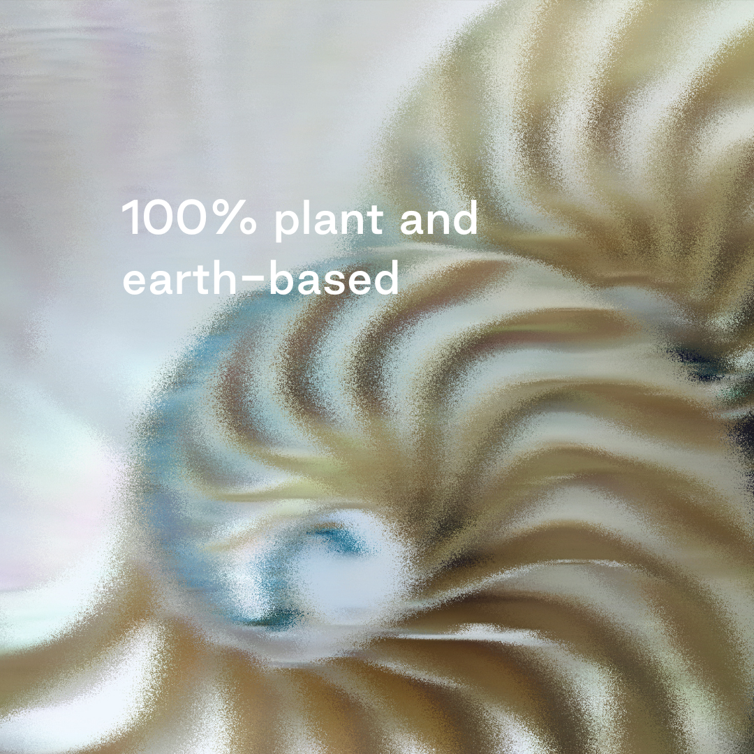 Close-up of a nautilus shell with text '100% plant and earth-based' on a light background