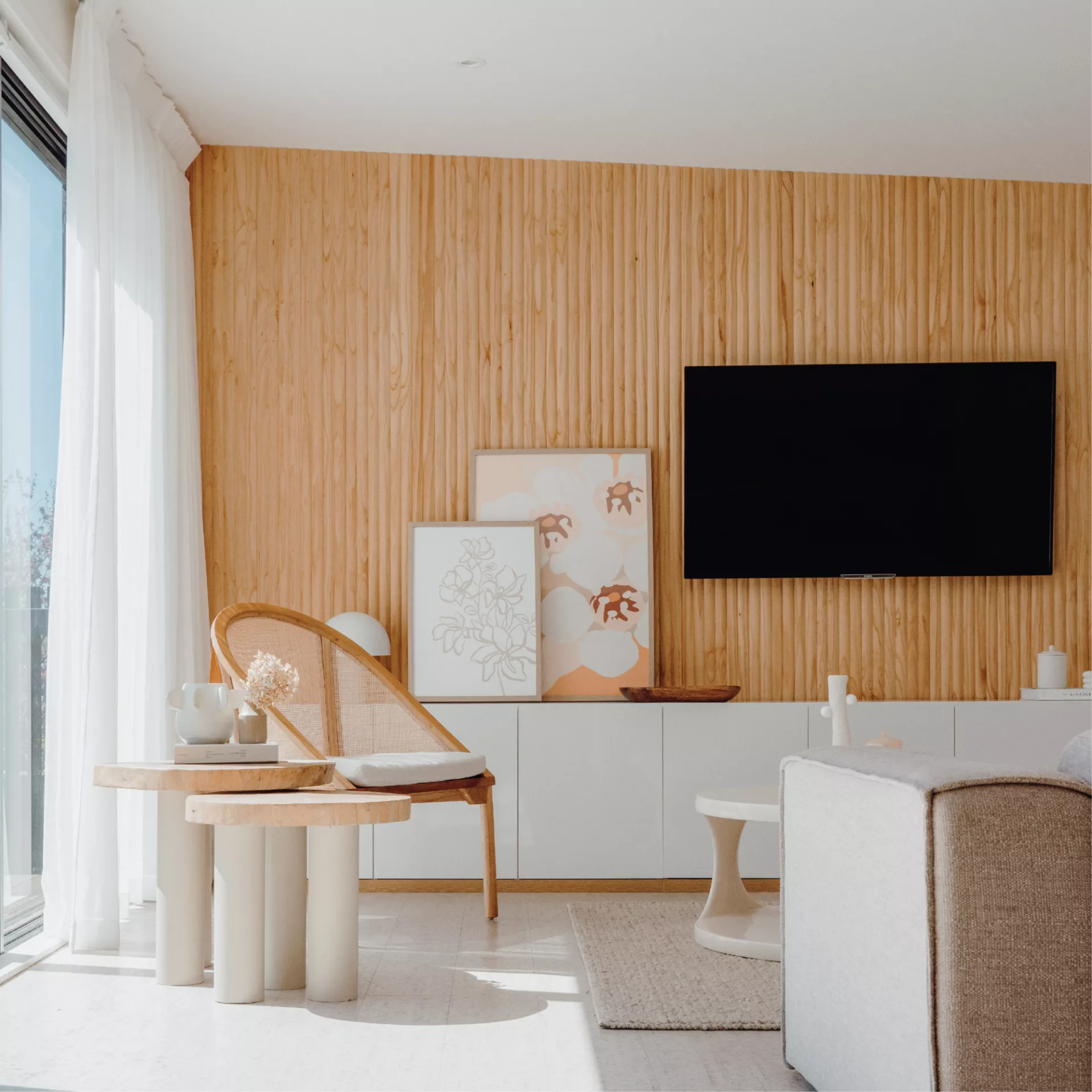 Modern living room with wooden wall, TV, and furniture